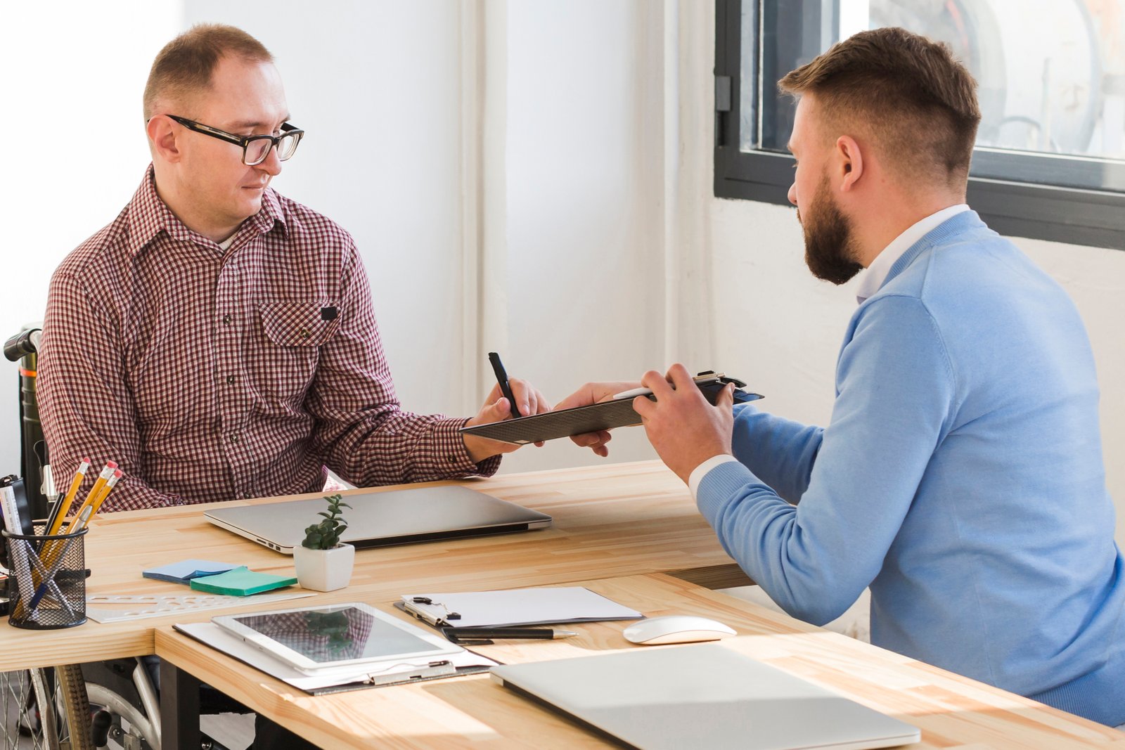 adult-males-working-together-office